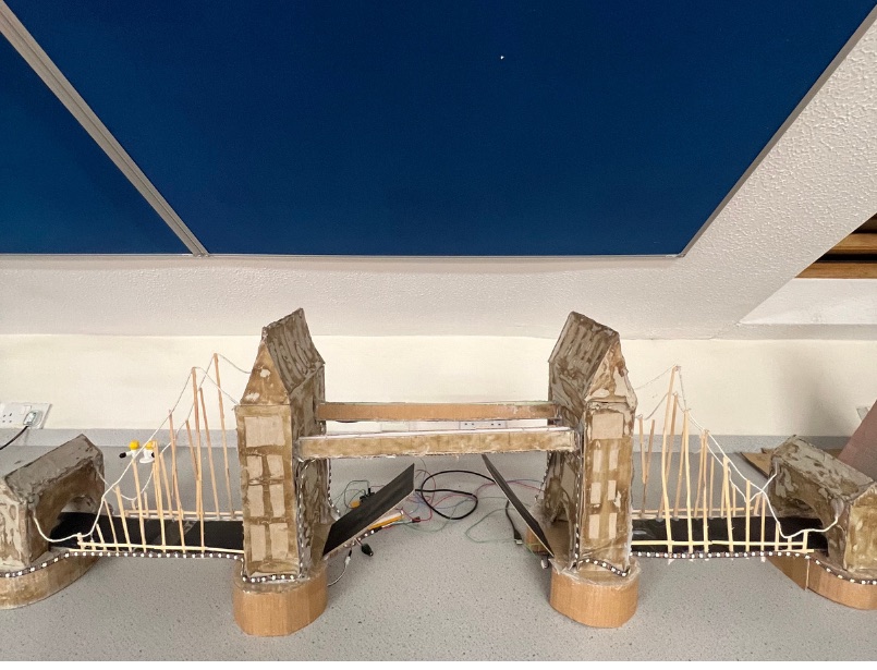 Student-built cardboard model of Tower Bridge with LED light strips